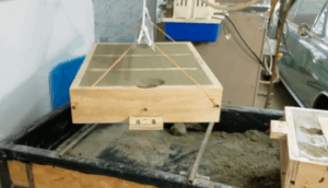 Hoist to help separate and roll large sand molds