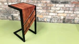 Red Oak Wood and Black Steel DIY C Table on Green Concrete with Brick Background